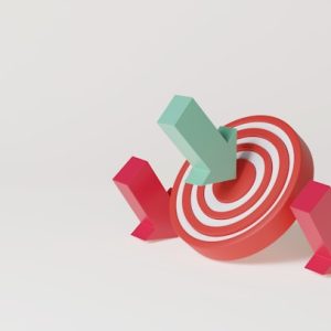 A 3D style of a target with a green arrow in the bullseye and two red arrows fallen by the side.